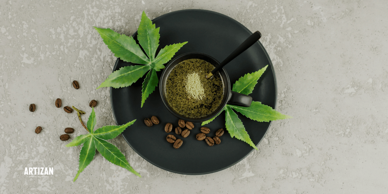 An image of a cup of coffee beside with coffee beans and leaves