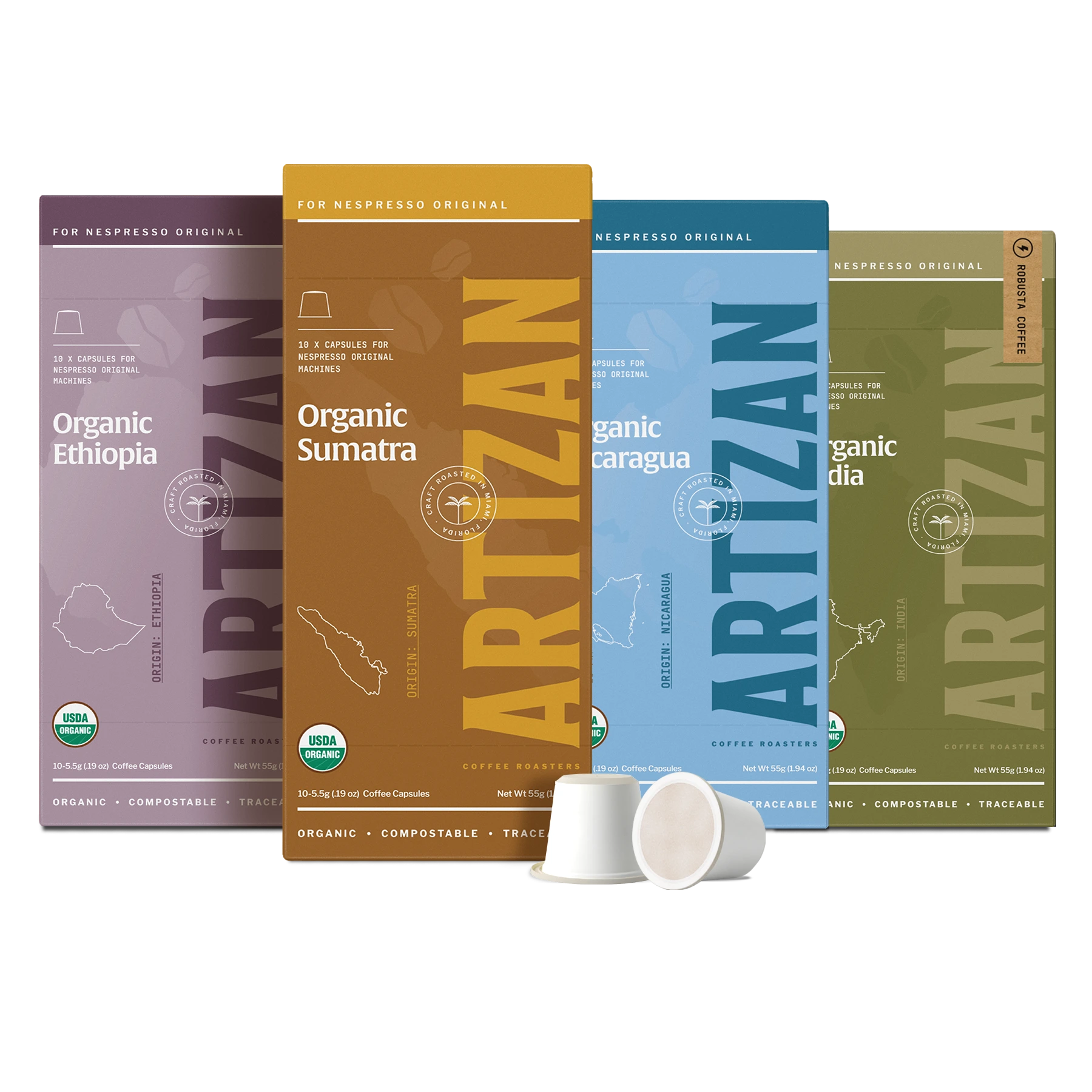 Artizan Nespresso-compatible organic coffee capsules "Around the World" bundle, featuring four single-origin varieties: Organic Ethiopia (purple box), Organic Sumatra (brown box), Organic Nicaragua (light blue box), and Organic India (dark green box).