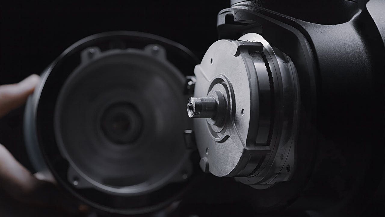 Close-up of exposed burr mechanism inside a commercial coffee grinder, showcasing high-quality construction and durability.