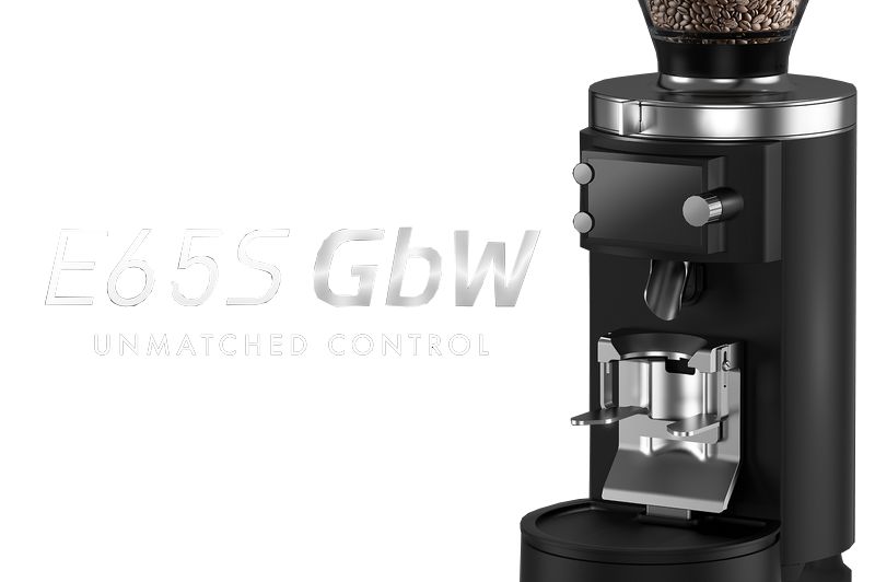 An image of Mahlkonig E65S GbW Espresso Grinder with a descriptive text of "Ë65S GbW UNMATCHED CONTROL"