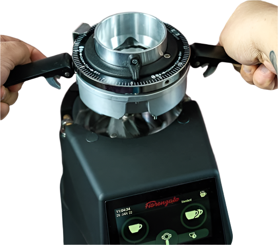 A man adjusting at the top part of Fiorenzato F83 E PRO On Demand Espresso Grinder