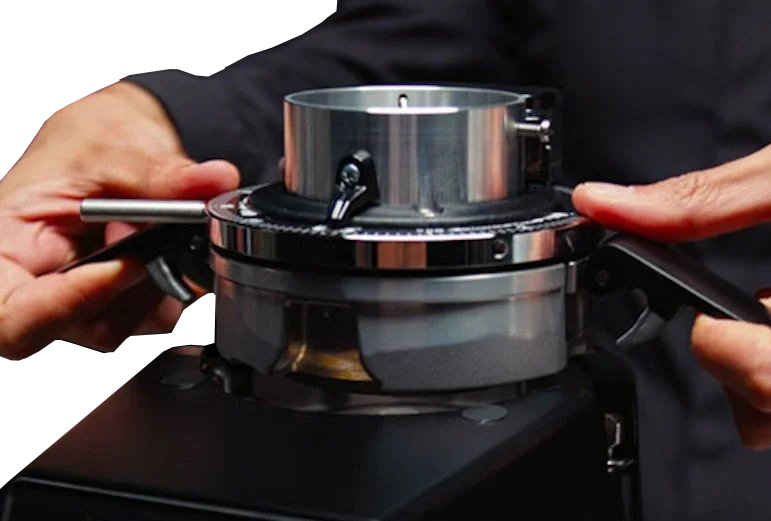 A man adjusting the top part of Fiorenzato F83 E PRO On Demand Espresso Grinder