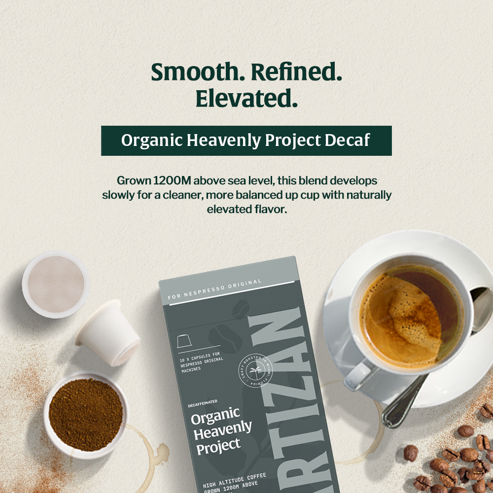 A cup of coffee of Heavenly Project Decaf with a statement above saying: Smoth. Refined. Elevated. Organic Heavenly Project Decaf. Grown 1200M above sea level, this blend develops slowly for a cleaner, more balanced up cup with naturally elevated flavor.