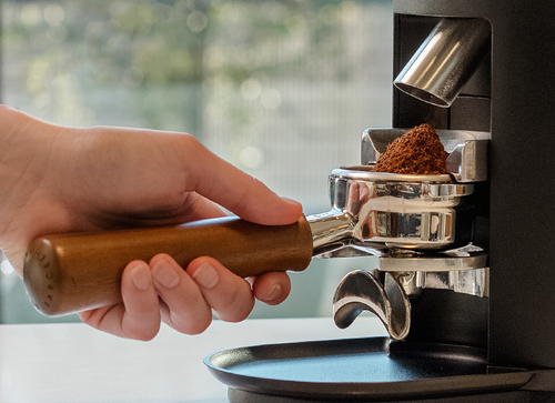 Close-up view of 54mm flat burrs inside a Mahlkönig grinder for professional coffee grinding accuracy.