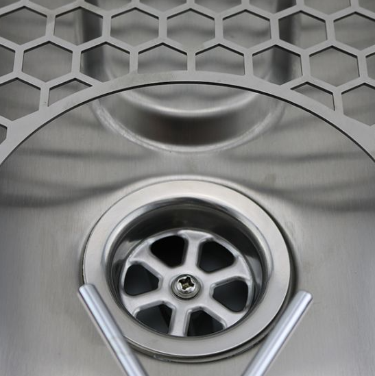 A close up look of Rhino Pitcher Rinser - 600mm - Spinjet on the drain.