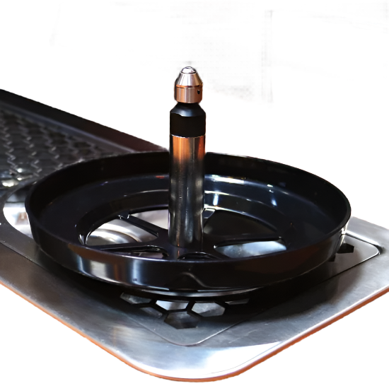 An image of Rhino Spinjet spray valve with black coiled stainless riser and actuator star in rinser tray—360° sweeping rinse action for efficient cleaning