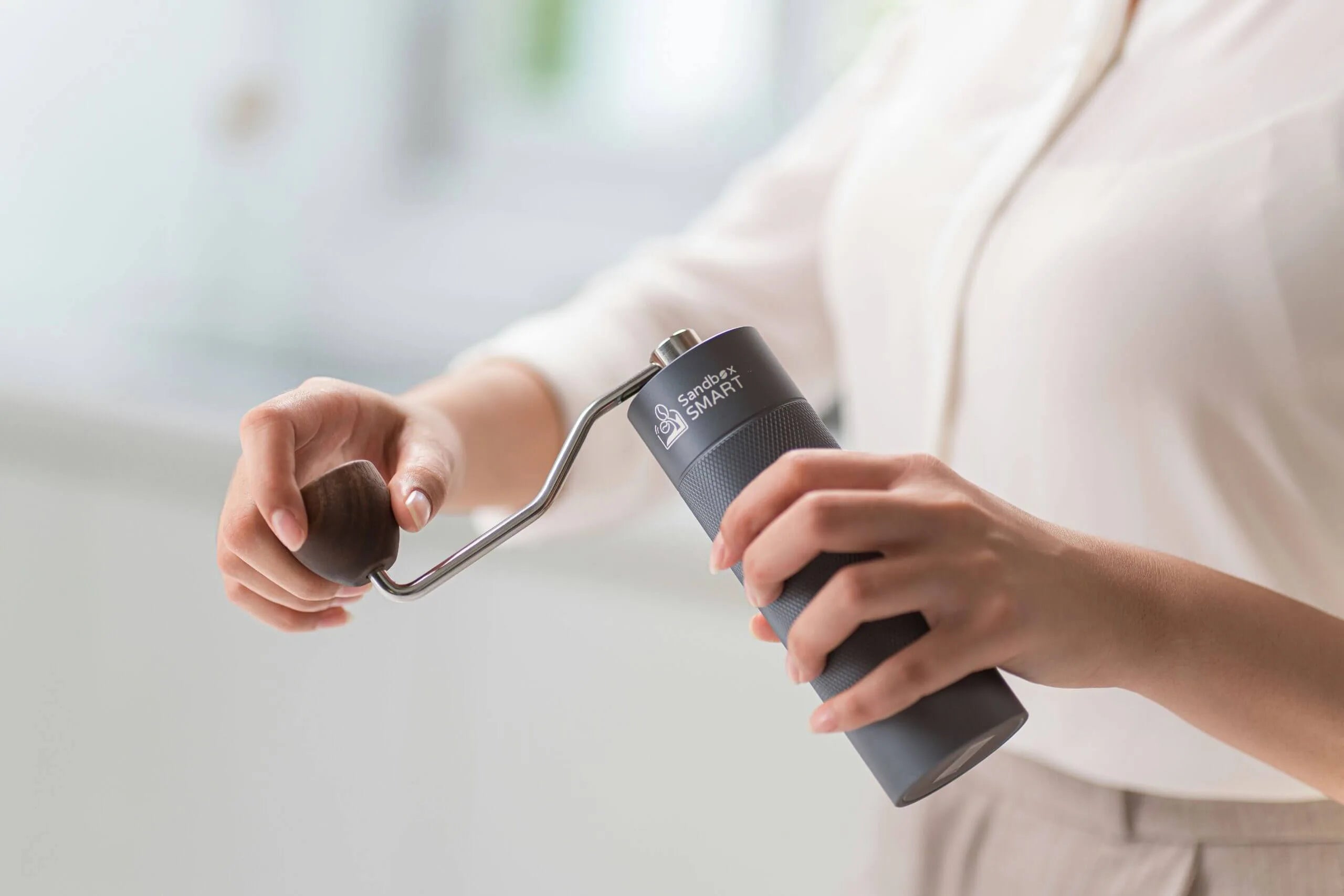 Barista using the Sandbox Smart G1 Coffee Grinder