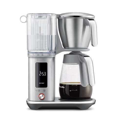 Top-down view of The Luxe Brewer Glass coffee brewer showing open stainless steel filter basket positioned above the glass carafe for precise drip brewing.