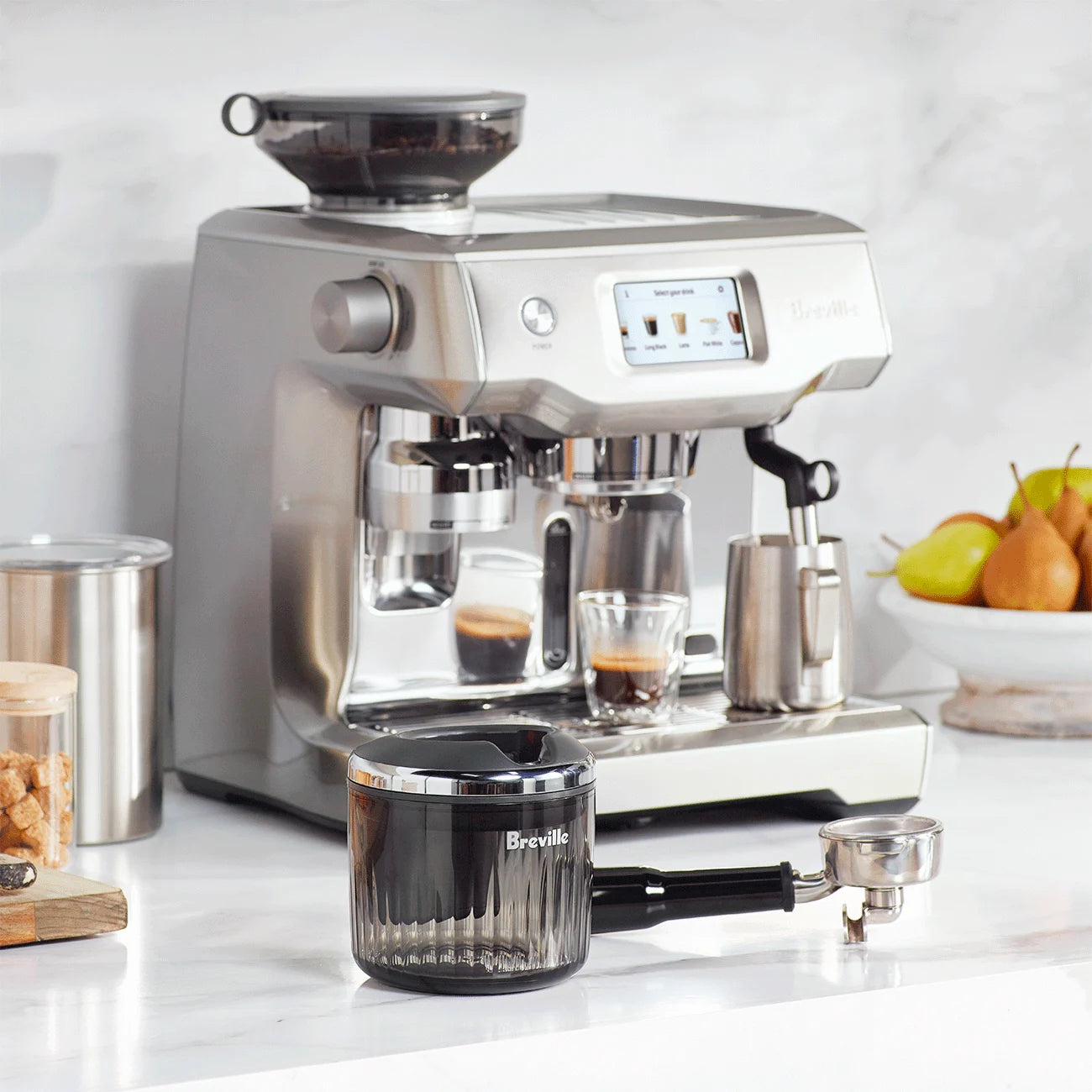 Side view of The Puck Suker showing compact design, black handle, and stainless steel suction base