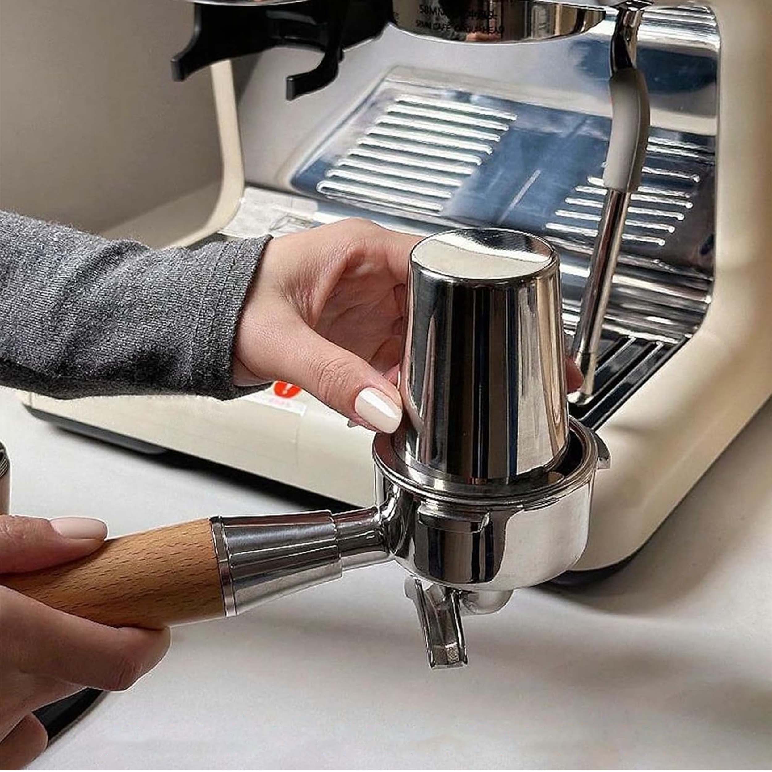 58mm stainless steel espresso dosing cup placed on portafilter, compatible with espresso machines for precise coffee dosing and clean workflow.