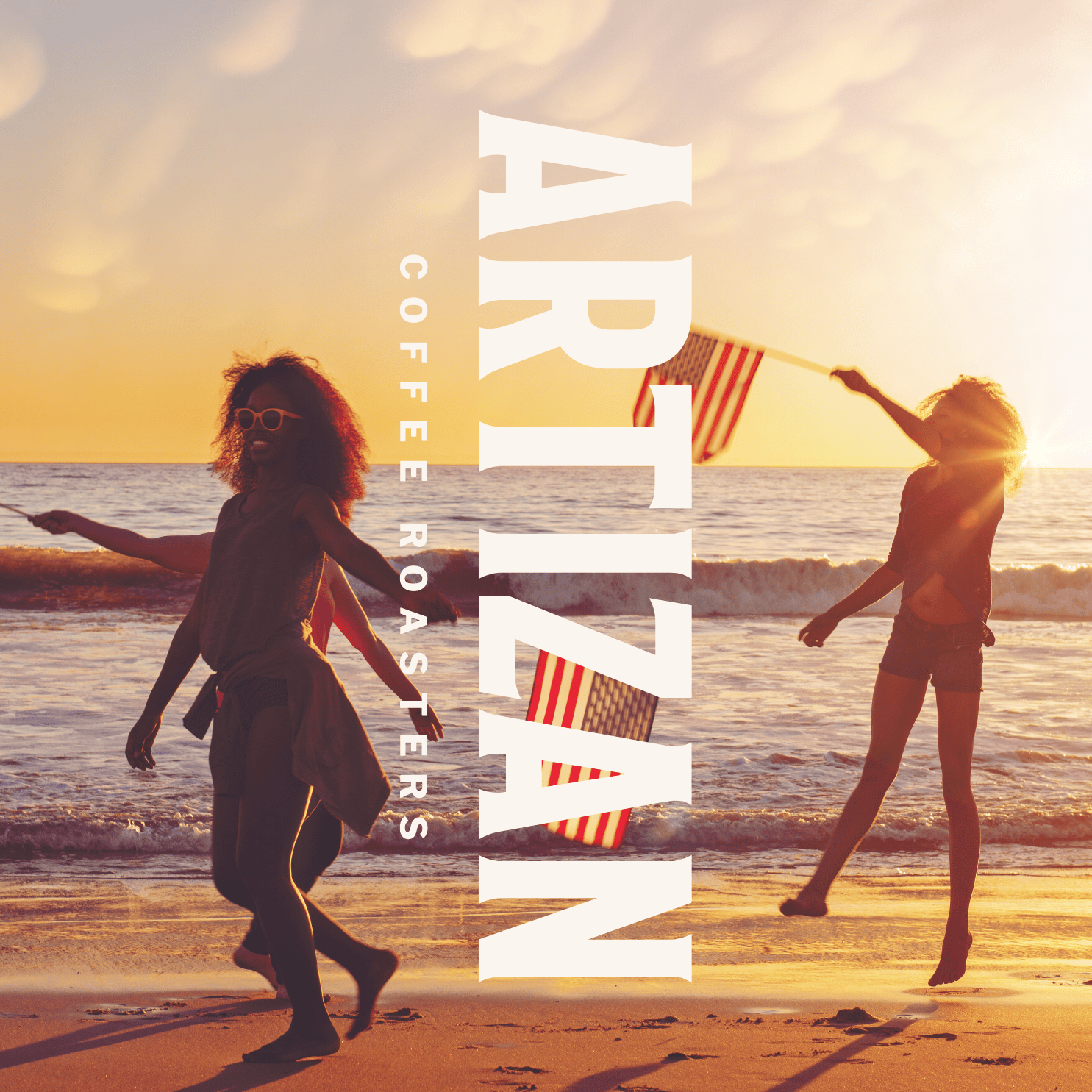 Three woman on a beach with American flags, featuring the Artizan Coffee Roasters logo.
