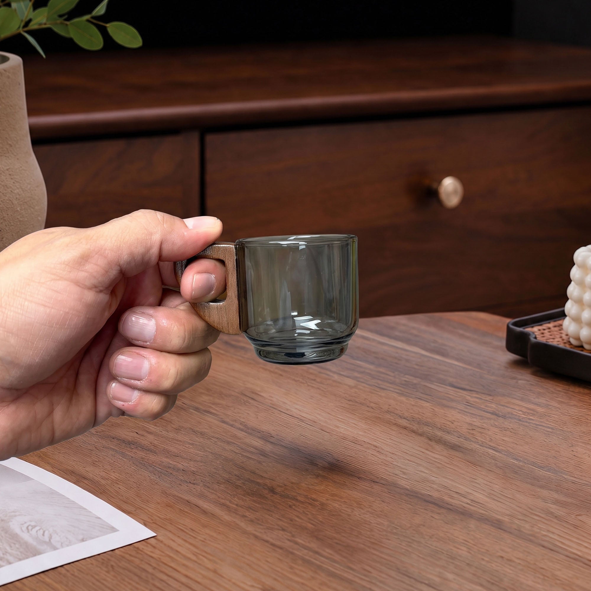 holding Handcrafted Glass Espresso Cup with Wooden Handle