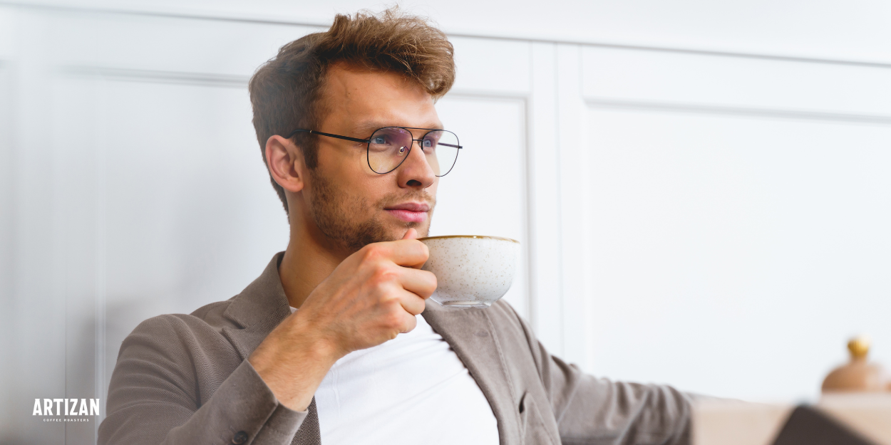 a man holding a cup of coffee