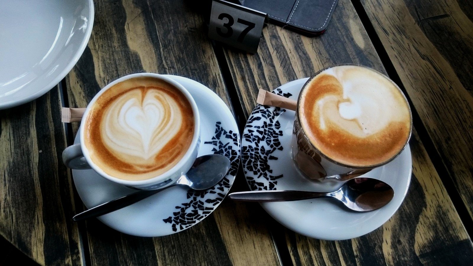 Image of Two Cups of Coffee on a Table one Flat White and the Other Caffee Latte 
