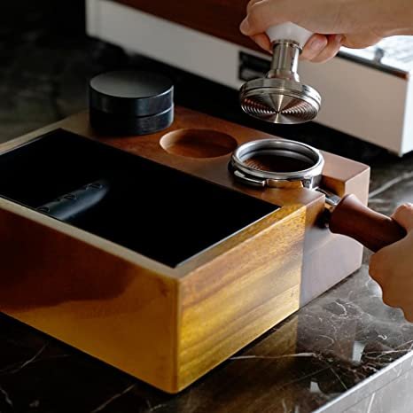 Close-up of 58mm knock box and tamping station