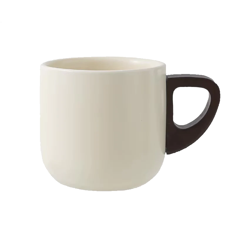 Modern ceramic coffee mug in cream color with a unique brown handle, perfect for hot beverages.