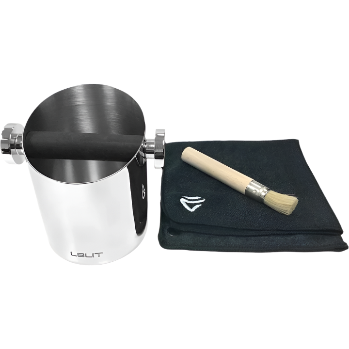 Stainless steel Lelit cylindrical knock box shown with wooden brush on top of microfiber cloth