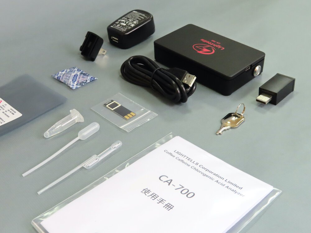 An image Lighttells CA-700 Caffeine & CGA Analyzer and other parts of it including a manual book