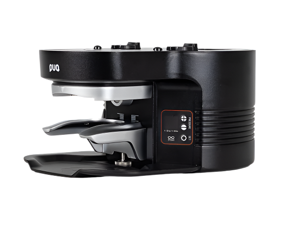 Puqpress M4 black coffee tamper angled front-right view with portafilter holder