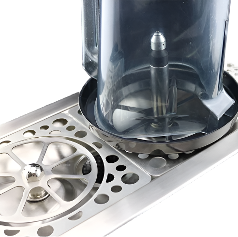 Close-up of Rhino rinser large blender actuator plate and Spinjet valve installed in honeycomb drip tray for rinsing blender jugs and milk pitchers