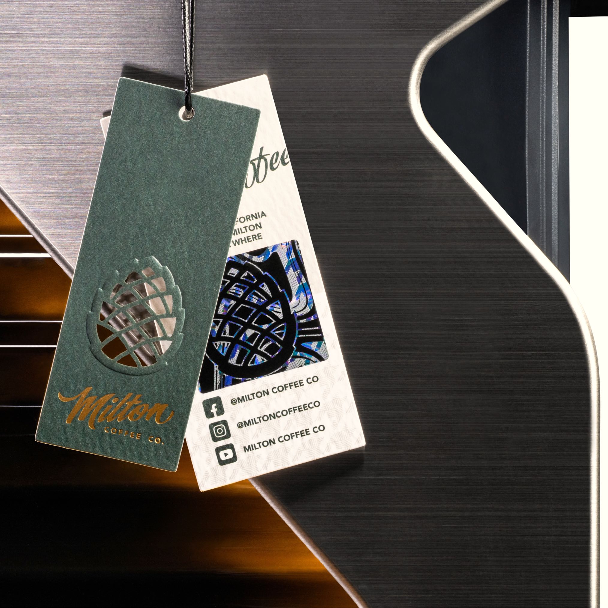Product tag detail of Line1 Espresso and Coffee Machine in Brushed Silver and Onyx on white background