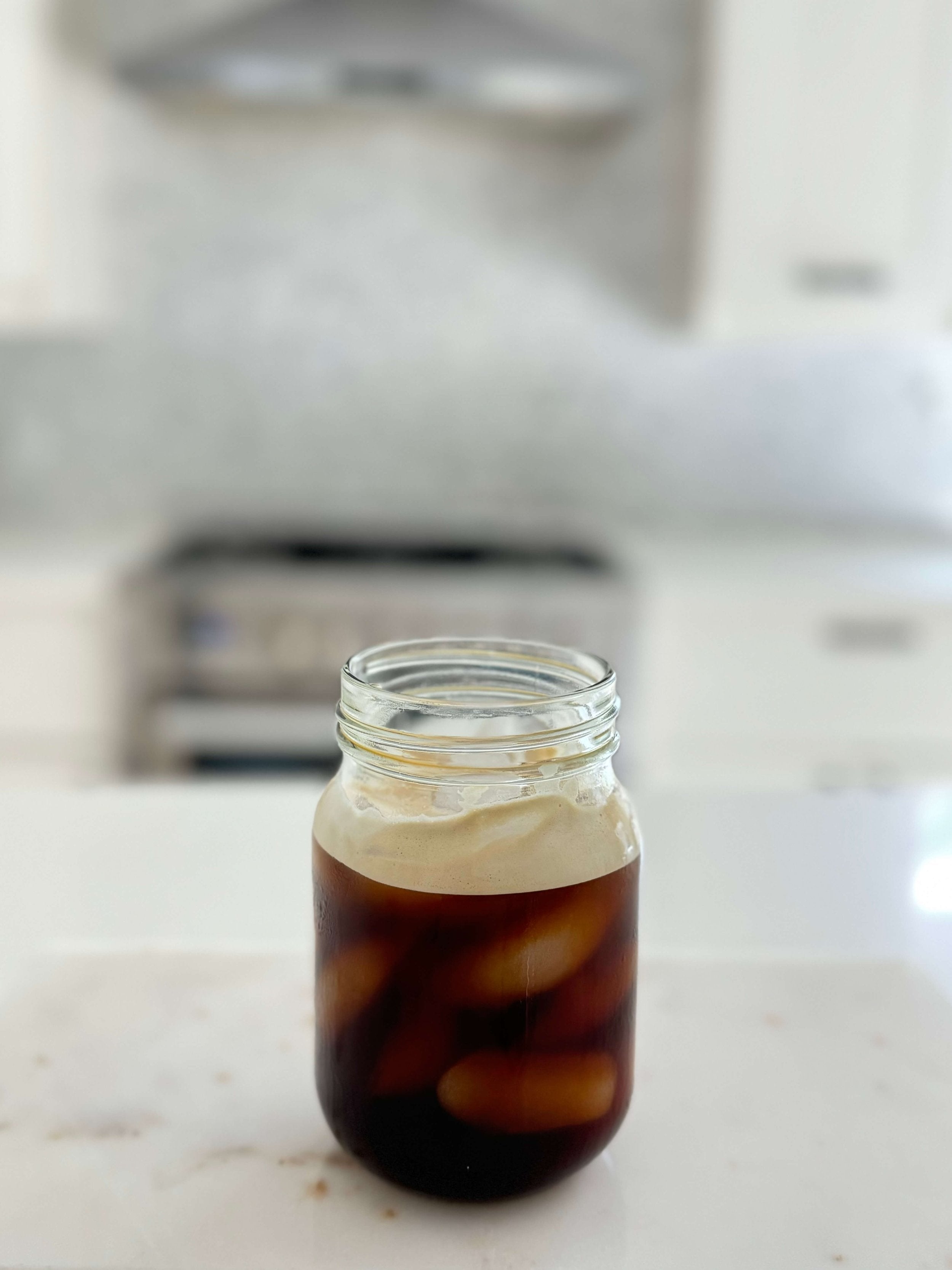 Glass jar filled with iced organic coffee
